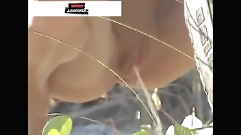 Garota mijando escondida atras knock off carro